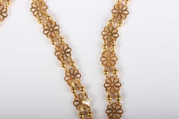 TooveysA gold necklace in a pierced circular and twin bead link design, unm