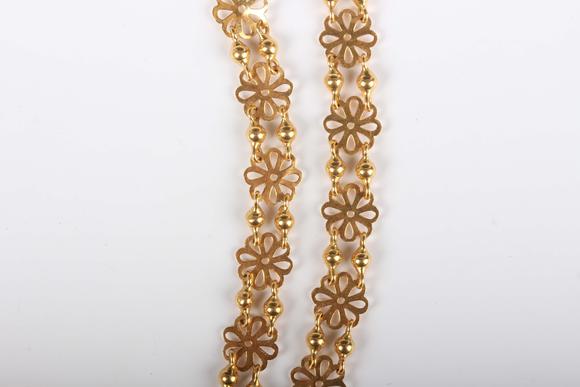 TooveysA gold necklace in a pierced circular and twin bead link design, unm