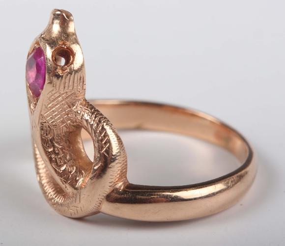 TooveysA gold, ruby and synthetic ruby ring, designed as a coiled snake, de
