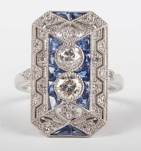 TooveysA platinum, sapphire and diamond panel ring in an Art Deco inspired