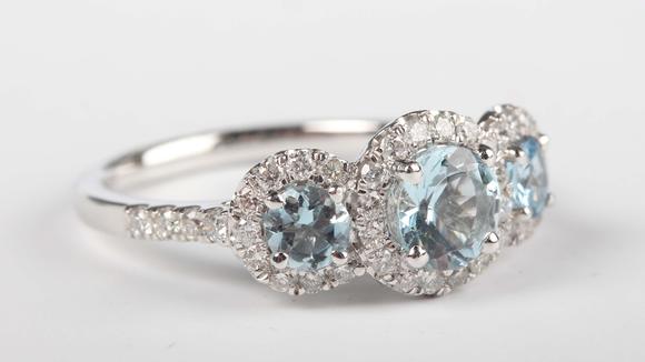 TooveysA platinum, aquamarine and diamond triple cluster ring, claw set wit