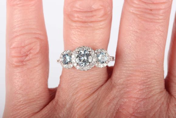 TooveysA platinum, aquamarine and diamond triple cluster ring, claw set wit