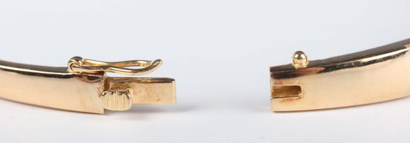 TooveysA gold, sapphire and diamond bangle, mounted with a row of nine cut