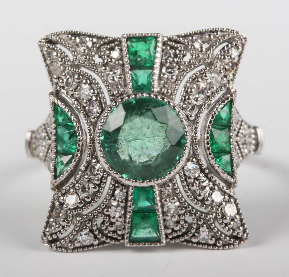 TooveysA platinum, emerald and diamond panel ring in an Art Deco inspired d