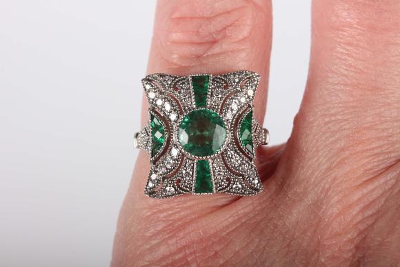TooveysA platinum, emerald and diamond panel ring in an Art Deco inspired d