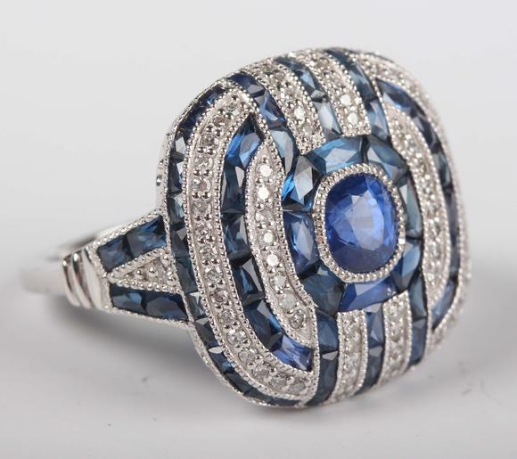 TooveysA platinum, sapphire and diamond panel ring in an Art Deco inspired
