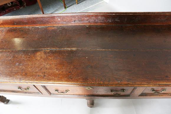 TooveysAn 18th century provincial oak dresser base, fitted with three drawe