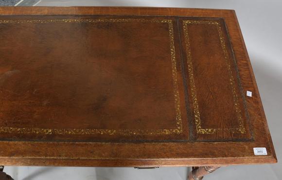 TooveysA late Victorian oak writing table, the top inset with gilt-tooled b