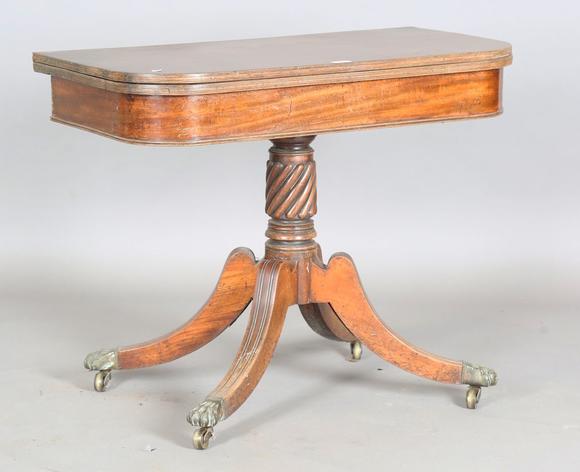 TooveysA Regency mahogany fold-over tea table, raised on a spiral reeded st