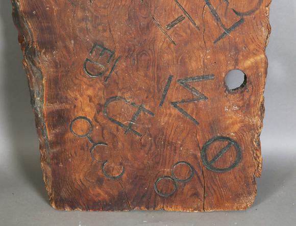 TooveysAn unusual wooden panel, covered in various incised letters and symb