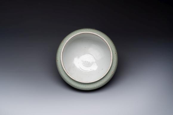 Rob Michiels AuctionsA Chinese celadon-glazed bowl with incised chilong among floral scrolls, Kangxi