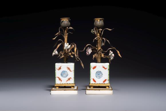 Rob Michiels AuctionsA pair of gilt silver and metal candlesticks with Chinese porcelain, European porcelain flowers, and marble bases, marked Boin-Taburet, late 19th C.