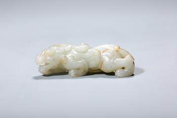 A Russet-Inclusion White Jade Recumbent Chilong Dragon, China, 2nd–1st centuries BCE