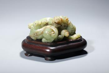 A Yellow Jade Group of Intertwined Chilong Dragons, Wood Stand, China, 14th–17th centuries