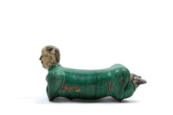 POLYCHROME SANCAI CERAMIC SCULPTURE DEPICTING A RECLINING CHILD, China, late 19th / early 20th century