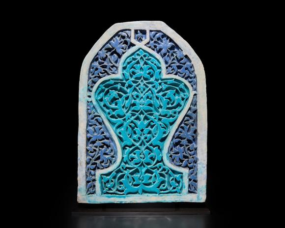 RoseberysA large turquoise and cobalt blue glazed carved pottery tile or pane