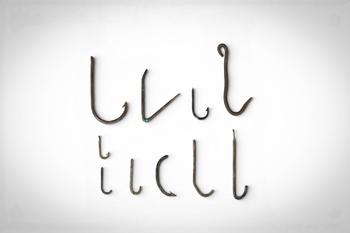 Ca. 1st - 4th century AD. >
A group comprising ten bronze fish hooks of varying size and form, in