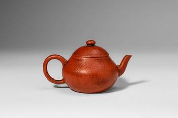 Qing Dynasty, Ca. AD 1644 - 1912. >A Yixing stoneware teapot of compact, globular form, the round