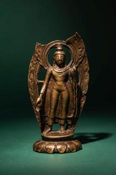 Ca. 10th - 11th century AD. >
A finely cast bronze figure of Buddha Shakyamuni standing in a fron