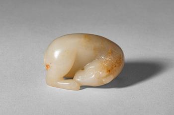 Mid Qing Dynasty, Ca. 18th century AD. >
A carved jade figure of a recumbent horse, depicted in a
