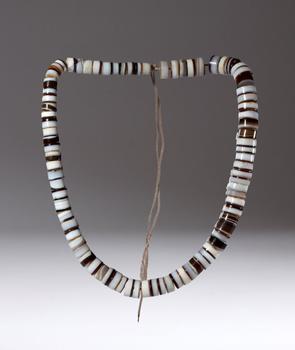 A necklace of discoid zoned agate beads. China, 19th century.