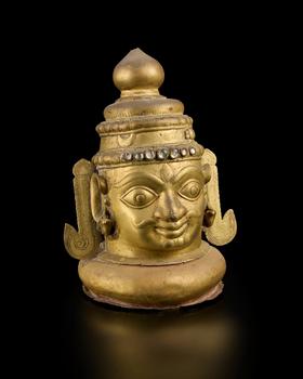 A large brass Siva lingam cover,
Western Deccan, 18th-19th century,

with bulging almond eyes, flat nose and full lips, wearing naga-shaped earring