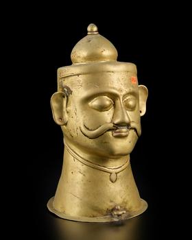 A large brass Siva lingam cover
Western Deccan, 18th-19th century,

with almond eyes under curved eyebrows, with strong serpentine moustache, weari
