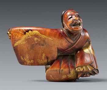 A small boxwood netsuke of a manzai dancer. 19th century