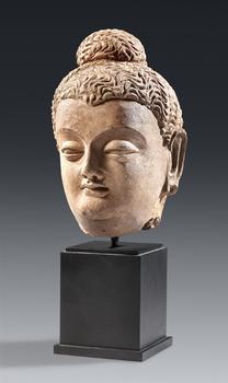 A Gandharan terracotta head of Buddha Shakyamuni. Pakistan. Kushan period, 3/4th century