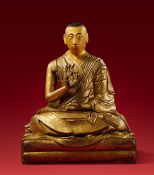 An important Tibetan fire-gilt copper alloy figure of a lama, probably Lobsang Yeshe, the 5th Panchen Lama. 18th century
