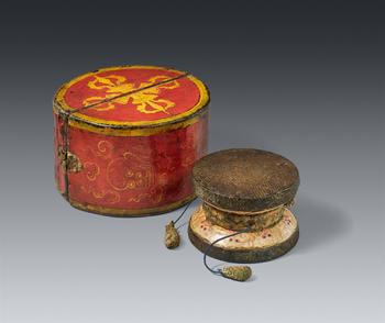 A Tibetan tantric wooden painted damaru with its original container. 17/18th century