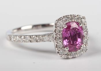 A platinum, pink sapphire and diamond cluster ring, claw set with th