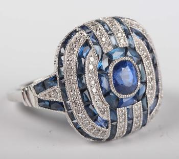 A platinum, sapphire and diamond panel ring in an Art Deco inspired