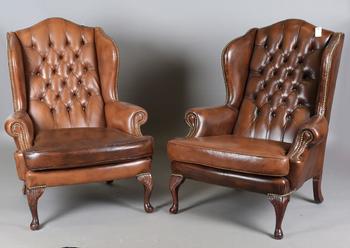 A pair of late 20th century George III style wing back armchairs, up