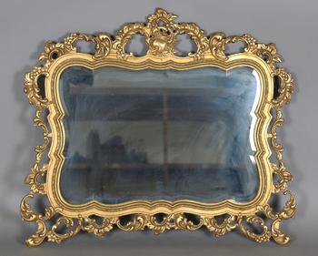 A late 20th century gilt composite wall mirror of shaped form, the f
