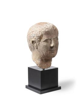 A CARVED MARBLE PORTRAIT HEAD OF A ROMAN MAN