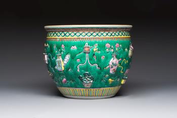 A Chinese famille rose green-ground 'Antiquities' fish bowl or jardinière with applied relief design, 19th C.